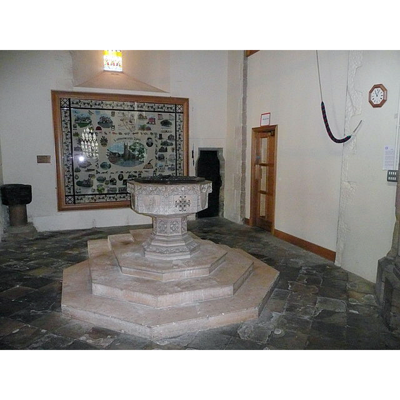 the 14thC (?) font on the left; the modern font in the centre