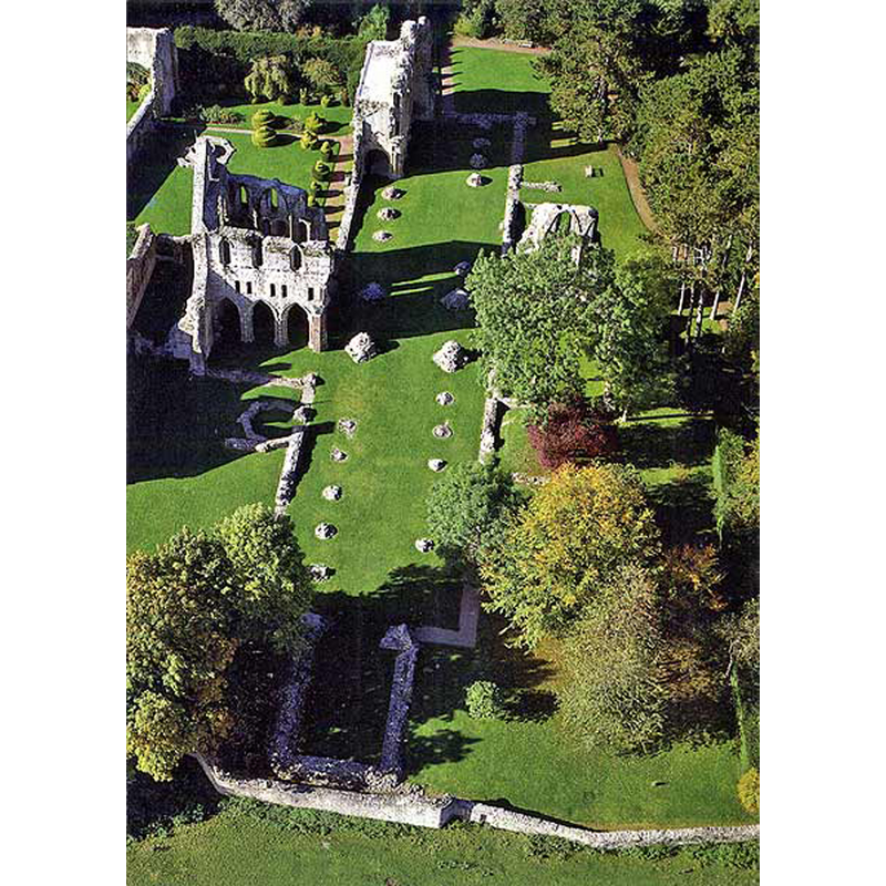 aerial photograph shows the interior plan of the ruined priory church; the wall structure of the north transept still standing, while most of the south transept has crumbled down