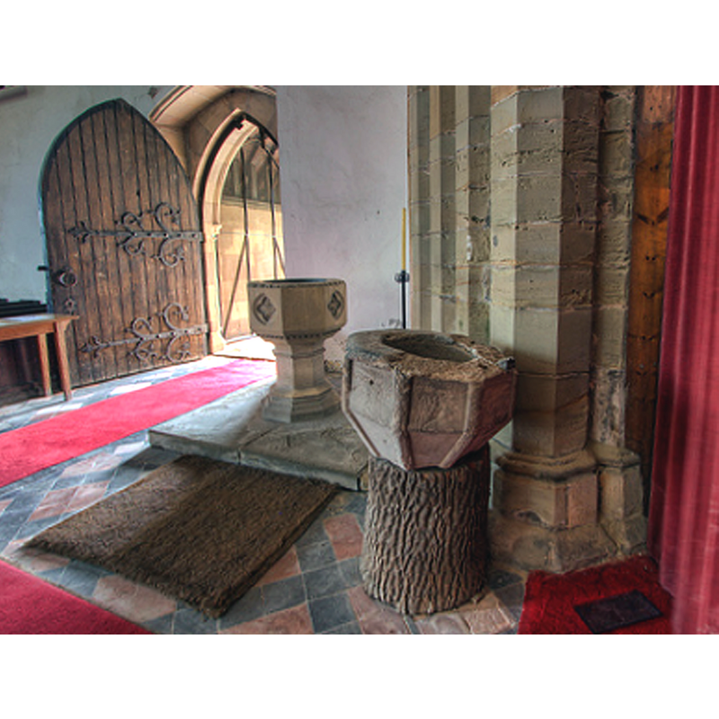 the two fonts in the context of the south doorway -- notice the damage around the upper rim of the old font