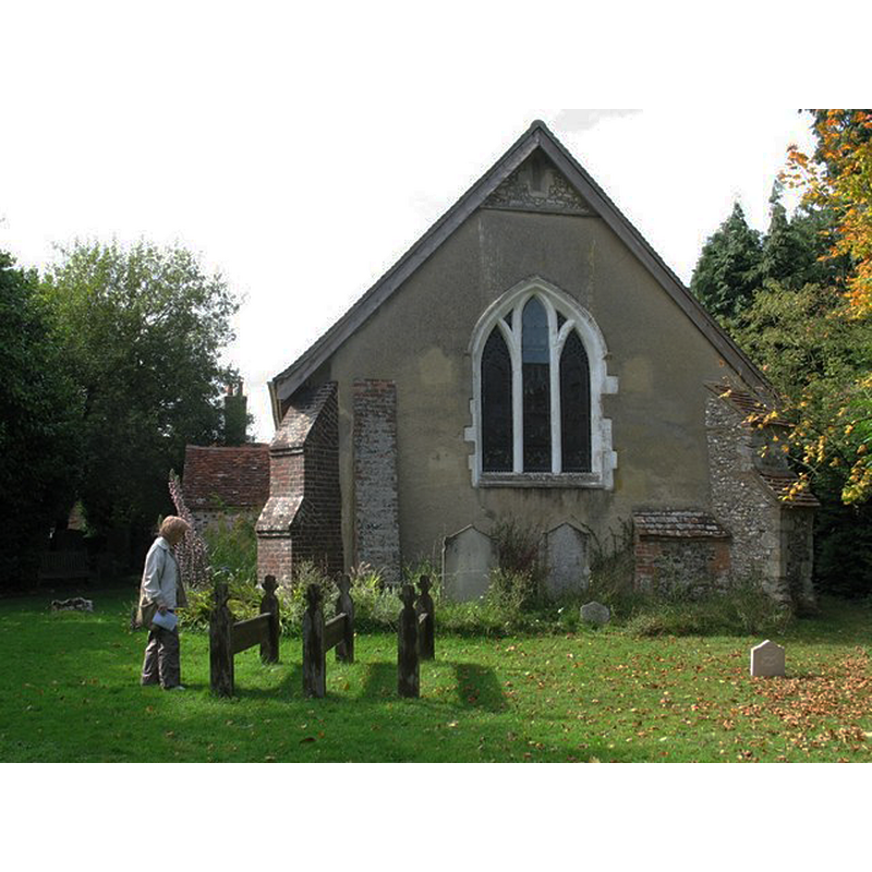 Source caption: "The village church of St John the Baptist is unusual. It consists of two buildings: an ancient chapel of ease built in the 12th century - which includes a window depicting Oliver Cromwell and John Hampden as 'champions of liberty', and the door shown here - and a Victorian red brick church built in 1867."