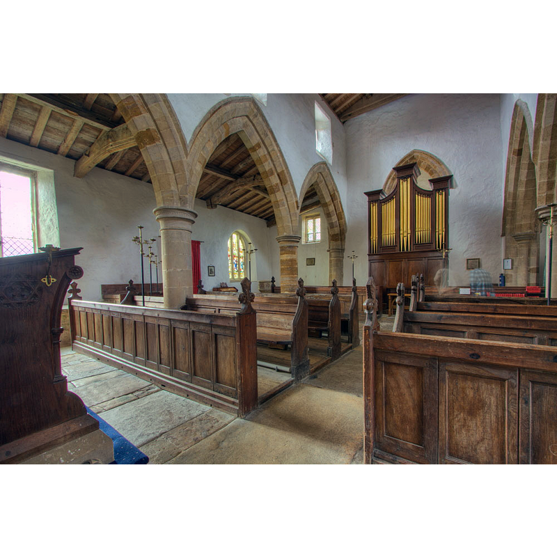 the modern font is partially visible at the southwest corner, south aisle