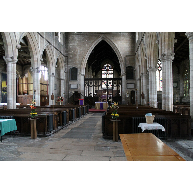 Source caption: "Interior of St Mary's church, Swineshead. St Mary’s Church, Swineshead, is built on the site of an earlier church dedicated to St Salvador and St Mary as there is a record of Alan de Croun, a local nobleman, making a donation to the church of this name “in the market there” in the early 12th century.
In the 14th century the present church was built of stone which was brought by barge up the Swin, a tidal creek at the head of which the village of Swineshead developed. Early patrons of the church were the De Grelley and De la Warre families and the church once contained stained glass windows with their coat of arms. Unfortunately these windows no longer exist. The rood screen dates from 15th century. Restoration work took place in 1847 when the chancel was rebuilt and the roof repaired at a cost of £2,000. This restoration was funded by Trinity College, Cambridge which had the advowson at the time. Again in 1868 further work took place when the nave was lowered by 14 inches to its original level and three blocks of new oak seating were installed. The floor was relaid in Ancaster stone, plaster and paint were removed from the walls and most of the windows reglazed. The money for this work was raised by subscription locally.
Church tower is 15th century and 160ft high."