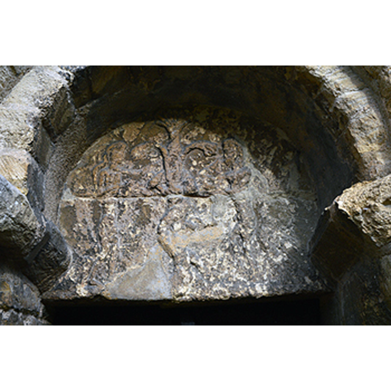 Source caption: "The tower has a wonderful tympanum over the south door showing Adam and Eve, the serpent and the Tree of Knowledge. Tympana such as this are quite rare in the county, which makes Thurleigh memorable."