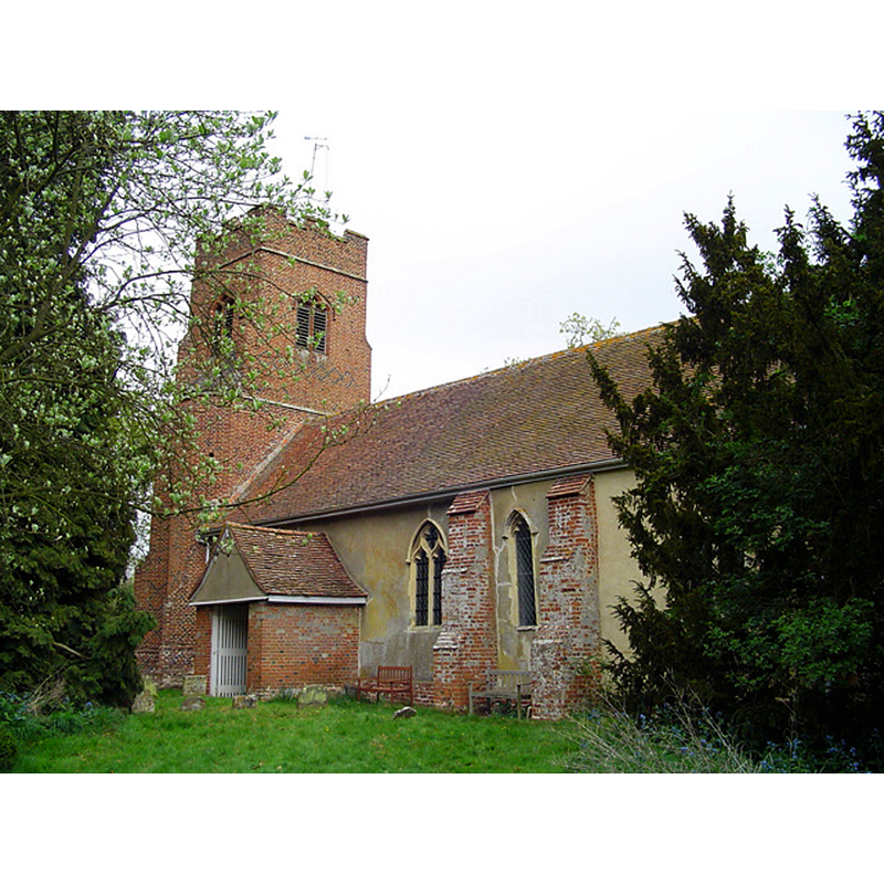 Source caption: "Waldringfield All Saints church. Standing close to the road, the tower catches the eye and immediately you wonder about the date. Well, it is Tudor and has turret stairs leading to the belfry. The walls of the church have been rendered with cement but the external character has not been lost. The porch is very simple. There is a good traditional East Anglian octagonal font with evangelical symbols around the bowl. Angelic faces peer down from the corbel and cross-legged figures pray around the shaft. Everything else is reproduction or new in 1864 when the Victorians ‘restored’ the church. The nave and chancel are austere and lack any warmth or character. On the south wall is a recent memorial to Sir William Bragg F.R.S. (1971)."