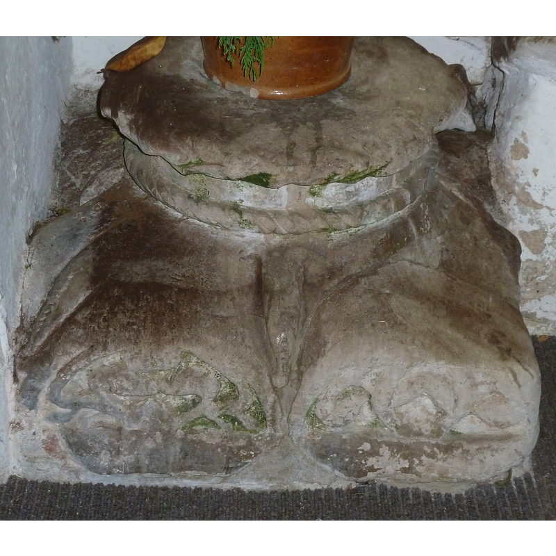 Source caption: "This is the base of an "Aylesbury" font [...] which presumably once stood in the nave of Wing's All Saints church, but is now to be found in the South Porch. However, this is something of an improvement in its fate, as I believe it was discovered buried in the churchyard some years ago."