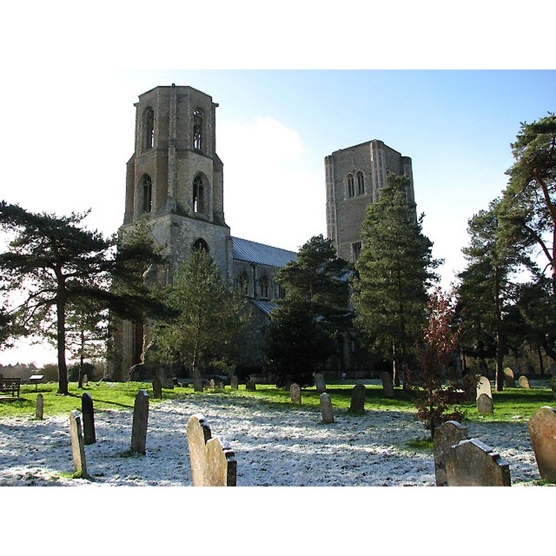 Source caption: "The twin towers of Wymondham Abbey. The church of St Mary & St Thomas of Canterbury, known as Wymondham Abbey, was the church of a Benedictine Priory that once stood here. The Priory became an Abbey in 1448 but was closed by Henry VIII in the 1530s; its remains can still be seen in the adjacent field. The church was completed during the 12th century. It used to be a cruciform church, with a length of 70 metres and twin west towers."