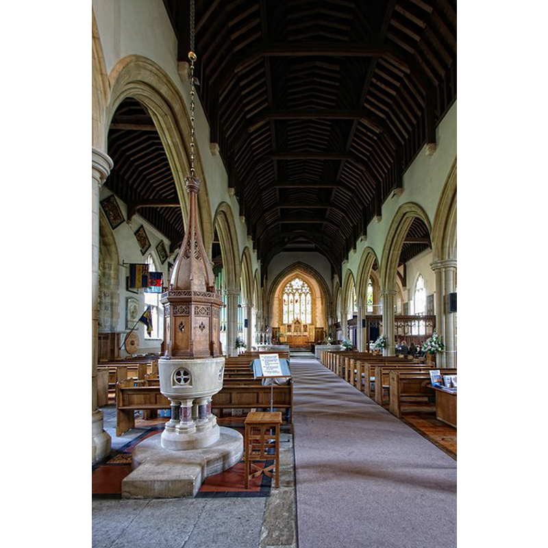 the modern font and cover at the west end of the nave, looking east