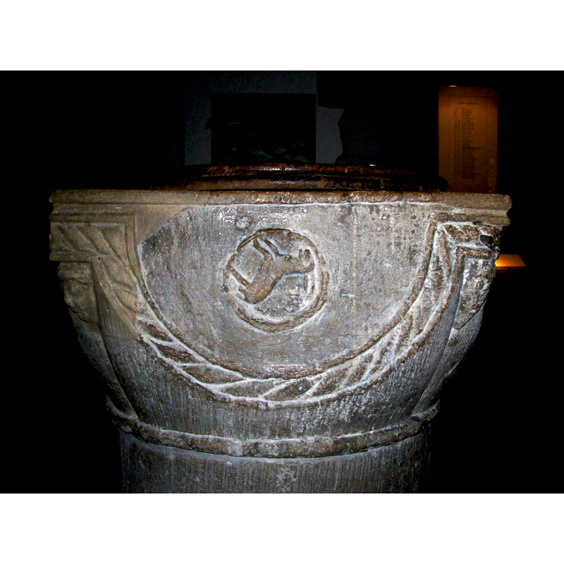 framing the rounded contours of the cushion-capital shape of the basin sides -- the upper left corner of the basin has been re-constructed showing the human face on it; the right corner is original and, unfortunately, is not much of a face anymore