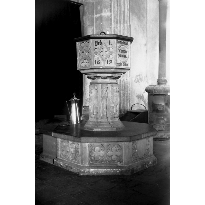 notice the coal stove behind and to the right of the font