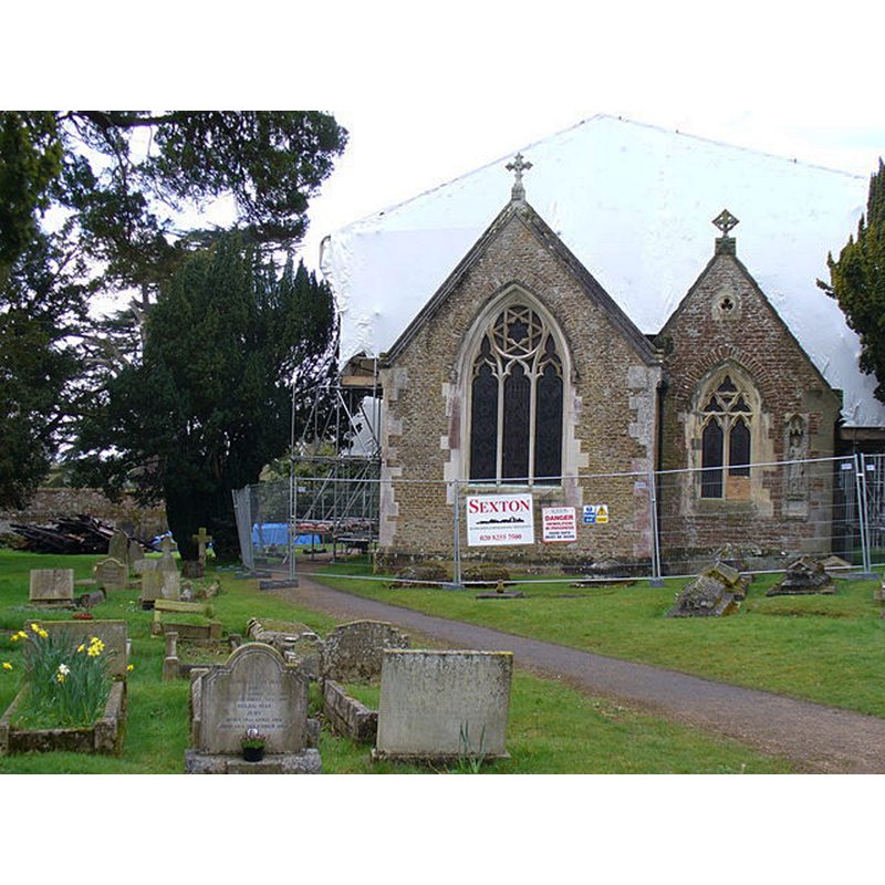 Source caption: "St Nicholas, After the Fire. The ancient church at Peper Harow was severely damaged by fire in December 2007 and is still closed to the public (March 2008) while forensic work is underway. The tower is hidden under large white sheeting while burnt timbers are visible on the left of this photograph."