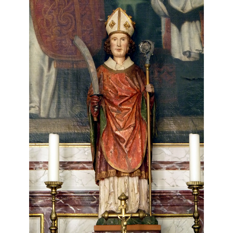 Source caption: "Beeld van Sint Follianus in de rechter zijkapel Follianuskerk Neerlinter" -- the saint appears here as a bishop, holding a rather scary curved weapon; he is said to have been murdered by outlaws; he had an active missionary role in the Brabant