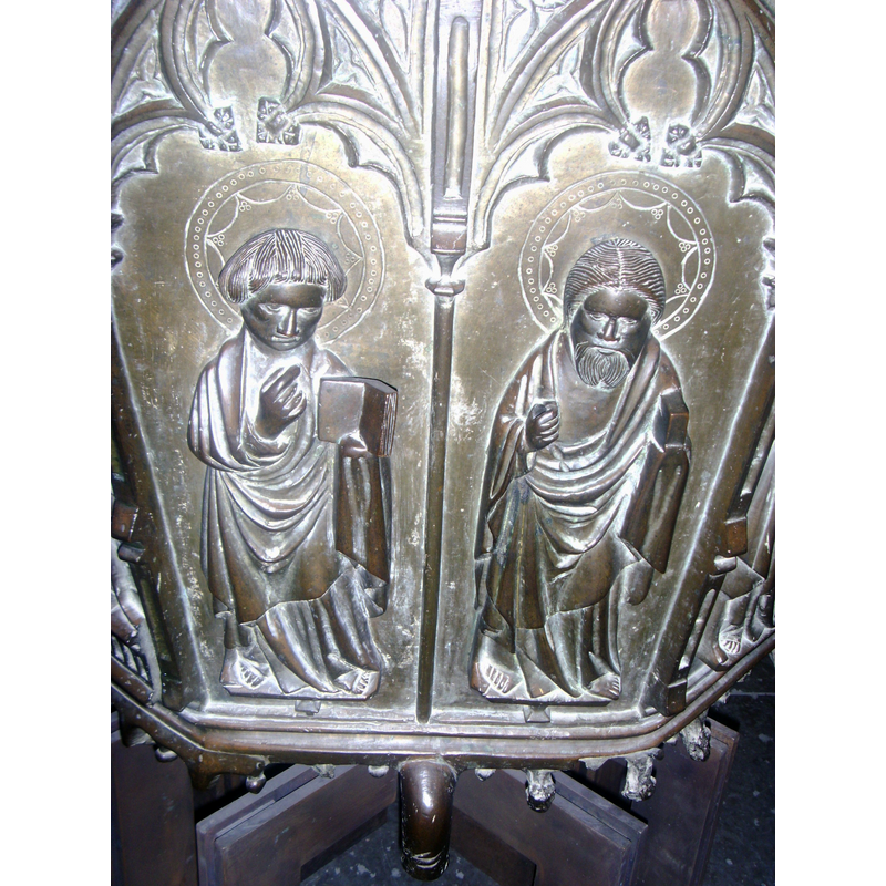 the Apostle on the left has no facial hair and is the obly one who holds an open book; also his right hand did not hold any other object; probably not John the Evangelist, as there is one other Apostle who is depicted without facial hair and holding a cup