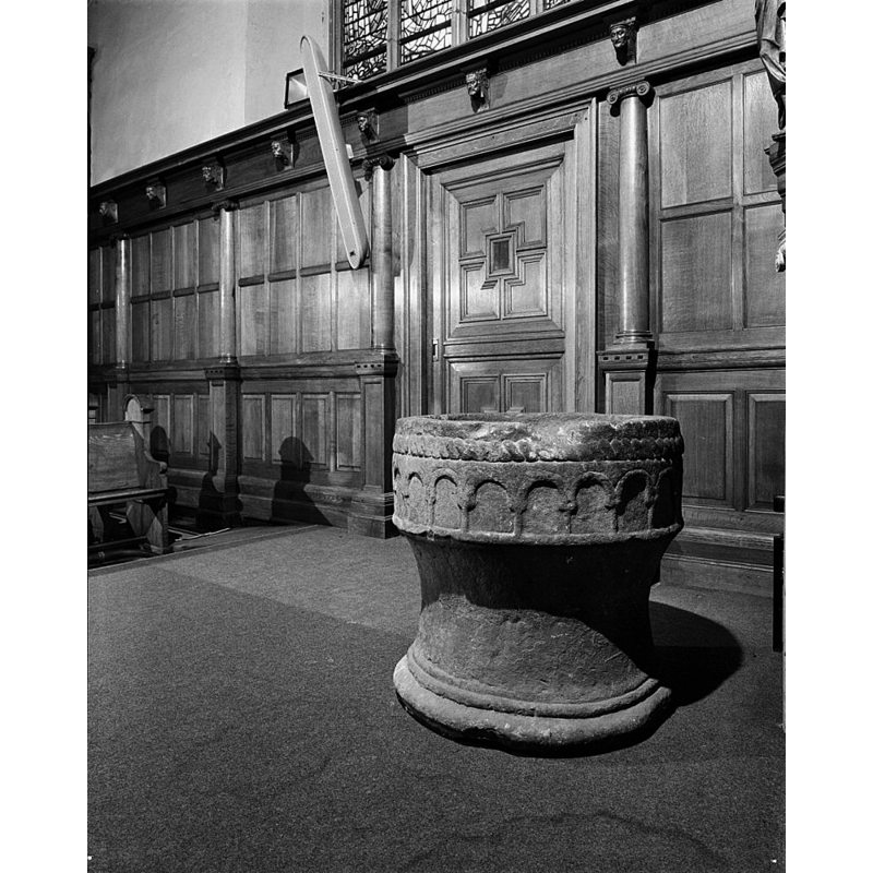 the font at the east end of the nave, towards the north side