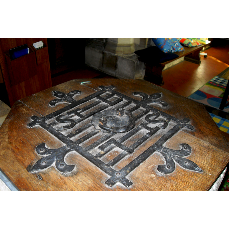 the modern font cover -- Source caption: "timber cover which has iron grid fret-work and a central ring for lifting. The letters ST L are incorporated twice and there are four fleur de lis on the sides of the grid" [cf. FontNotes]