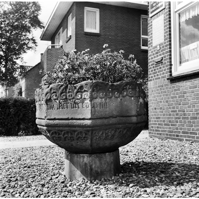 in 1967, as displayed in Veenhuizen, outside its owners house -- the font, which had been offered to the church in Onstwedde in 1950, would eventually be accepted back in Onstwedde and restored to Sint-Nicolaaskerk in 1989