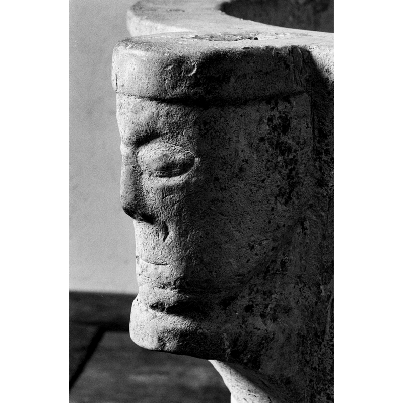 one of four, at 90-degree angles -- there is evidence on the top of the head of an anchoring plug (?) for an old font cover