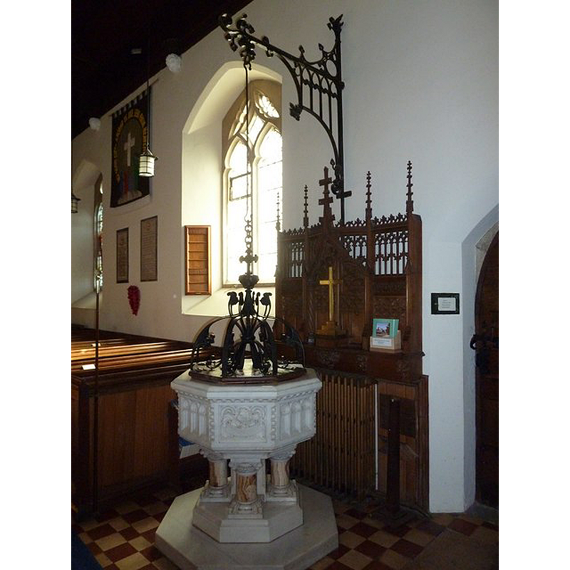 the modern font and its cover in the context of the church interior