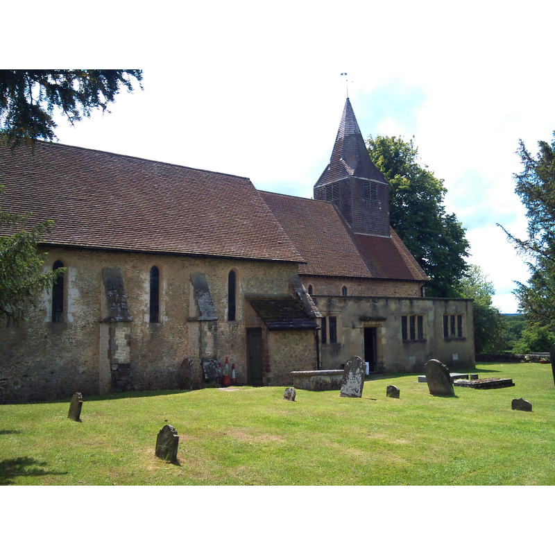 Source caption: "St James' Church, Abinger Common. The present church dates from at least the 12th century, if not earlier, and was rebuilt in the 13th century and in 1857. It was heavily damaged twice in the twentieth century, by a flying bomb on 3rd August 1944, and a fire resulting from a lightning strike in June 1964, but restored and rebuilt on both occasions."