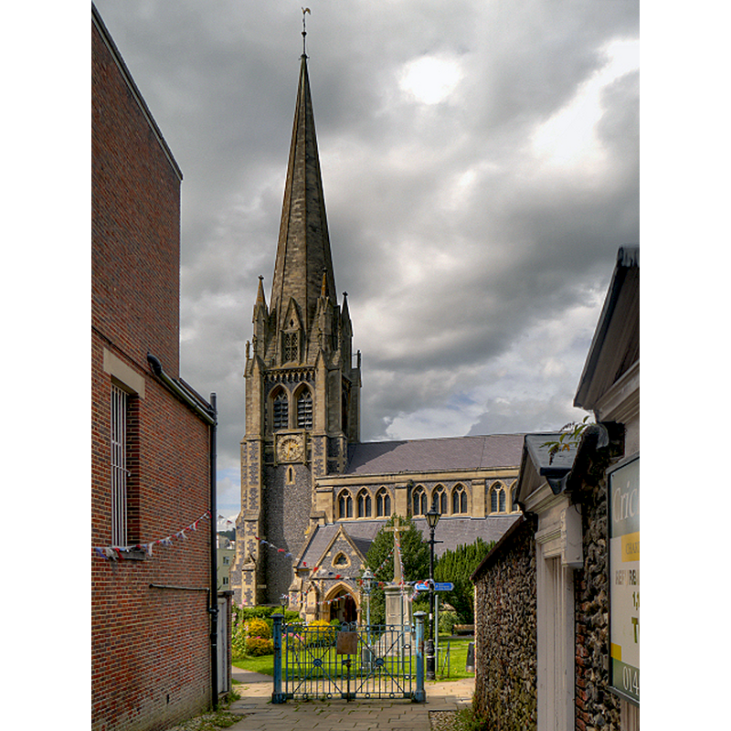 Source caption: "Dorking, St Martin's Church. St Martin’s is a Victorian building built between 1868 and 1877. It has one of the tallest church spires in England, the height to the weathervane being 210 feet. It is visible for miles around."