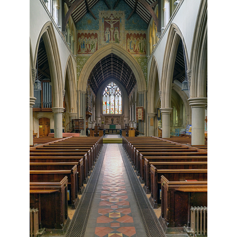 Source caption: "St Martin's Church, Dorking, Nave and Chancel Arch [...] Rebuilt by Henry Woodyer, between 1872 and 1874, the nave and aisles continue the design of his slightly earlier chancel in a grand and spacious 14th century decorated style. The Great Crucifixion over the chancel arch was designed by GH Rhead and made in 1892. The remainder of the decoration, with splendid archangels, was completed between 1901 and 1902 as a memorial to Queen Victoria. [source, "A look at St Martin's" published by the Friends of St Martin's, Dorking]"