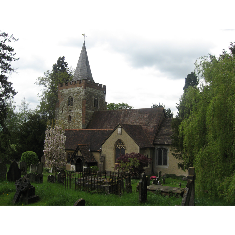 Source caption: "St Peter & St Paul’s Church, Nutfield. The oldest part of the church is 12th century. The west tower is of three stories. It is strengthened by diagonal buttresses at the western angles and has a stair-turret at its north-east corner. Over the tower is a shingled wood spire changing from square to octagon above the parapet, and crowned by a weather vane with the date 1767."