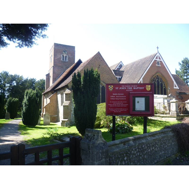 Source caption: "St John’s Church, Old Malden. Here are to be found the remnants of the old village of Malden, consisting of St John’s Church, the Manor House and Manor Farm. The flintwork of the chancel is medieval. The rest of the church is early 17th century. In 1875, a new nave and chancel were built, reducing the previous nave and chancel (seen here on the left) to a south aisle and south chapel."