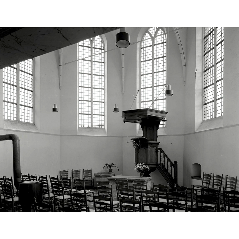 the chancel of the medieval church was coverted for use as a church in the 1960s; the incomplete baptismal font is seen here by the pulpit, in the tradition of the Protestant Reformed Church of the Netherlands