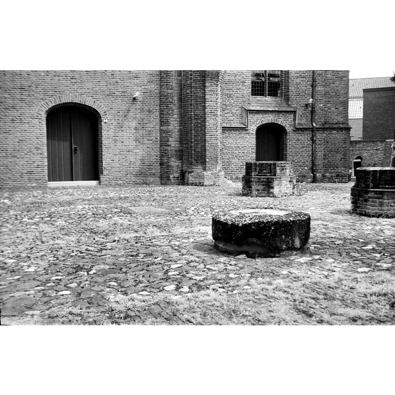 the large round (?) stone in the foreground, in what was originally the nave of the medieval church, as seen in May 1974 -- is it what remains of the early font here?