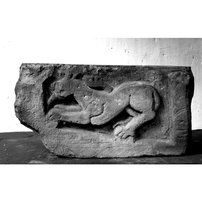 a fragment with a very dynamic-looking lion found in the excavations of the foundations of this church -- Source caption: "Oudheidkamer, reliëfstuk gevonden in de fudamenten van een huis bij de Sint Plechelmuskerk".