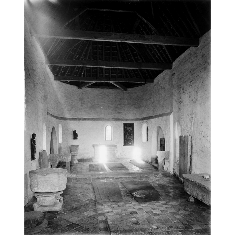 the interior of the church at Janum in 1960; the former church had become a museum in 1947 -- the Bentheim-sandstone font from Jellum is displayed in the foreground, left [north] side