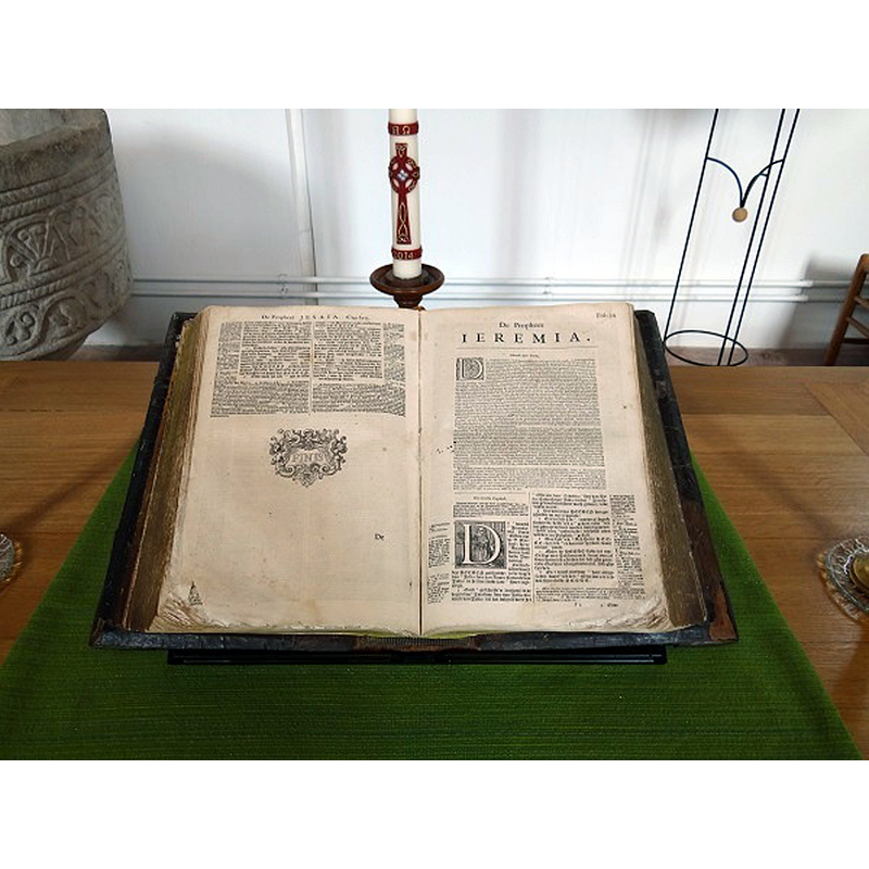 the font, partially visible here, in the interior of Vituskerk, Kantens. The Bible, open at the initial page of Jeremiah, stands opposite the pulpit; the font, in the tradtion of the NHK, never strays very far from the pulpit