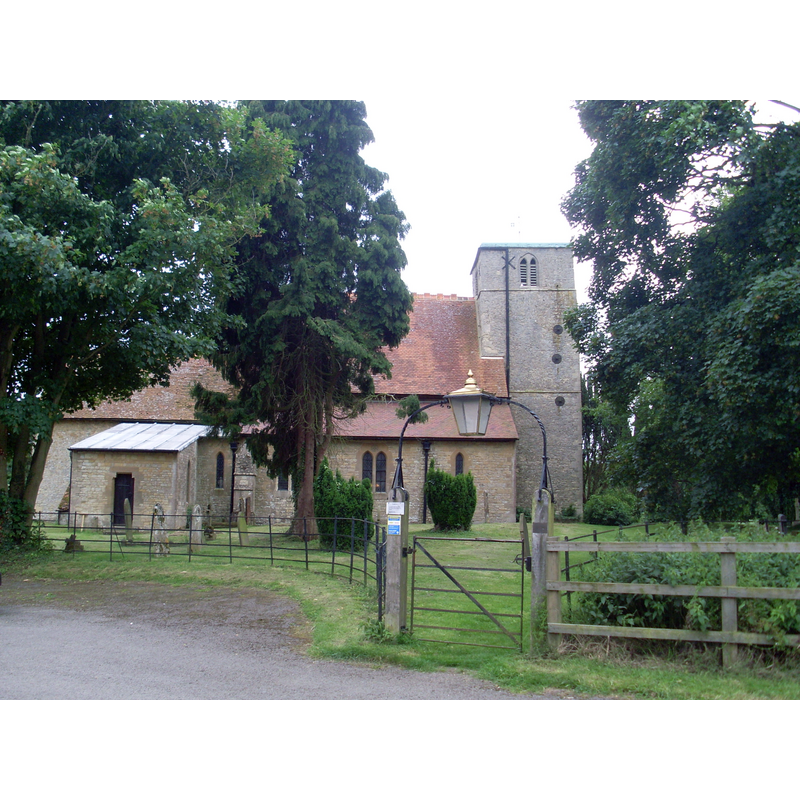 Source capton: "St Nicholas Church, Lillingstone Dayrell. Situated down a track off the A413 Main Road, this Parish Church is dedicated to St Nicholas of Myra. It is of grey stone with 11th-century nave and 13th-century tower and chancel. The Church was extended, restored and given expensive woodwork, tiles and stained glass by G.E.Street in the 1860s"
