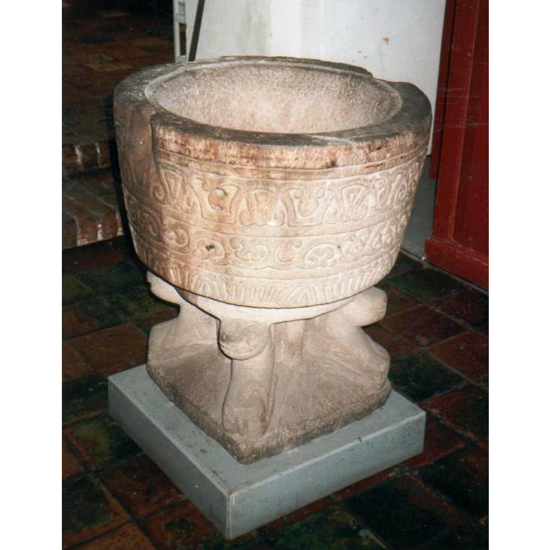 notice the groove around the upper rim, usually made to accommodate a cover of that shape and size; notice also the considerable damage at opposite ends of the upper rim, evidence of anchorings for an earlier font cover