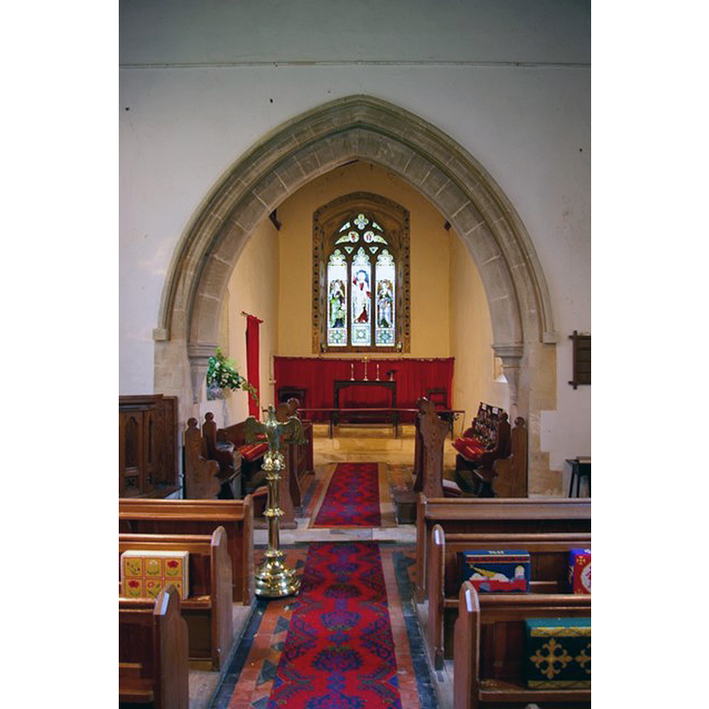 Source caption: "Interior of St Giles' Church. Showing the Early English chancel arch, the simple table altar and the late Victorian east window with stencilled surround."