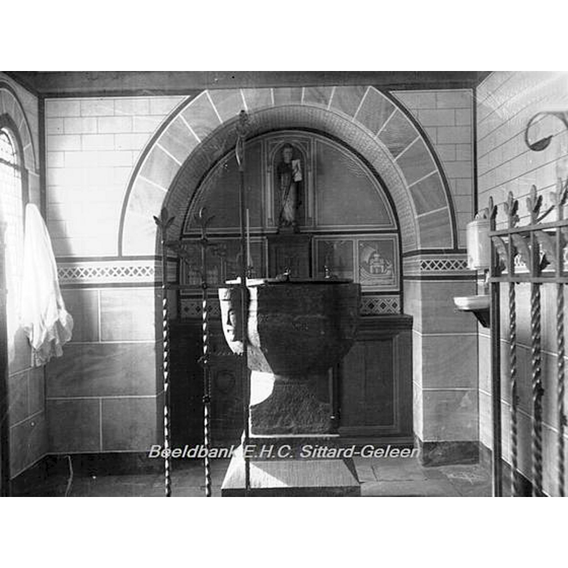 undated photograph showing the font in the context of the interior of the abbey church of St. Salvator, in Susteren [cf. FontNotes]