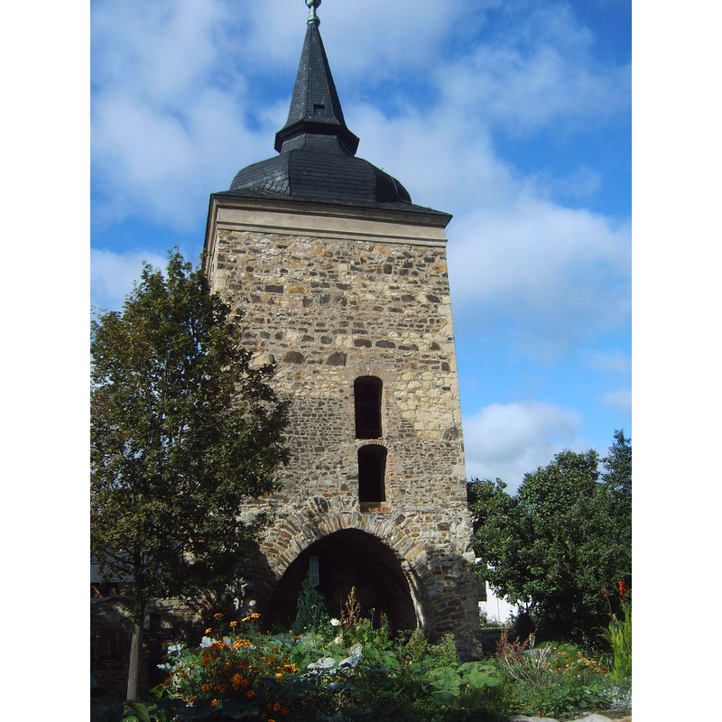 the restored outer shell of the tower is all that remains of the former parish church building destroyed in WWII; it is used for summer services only