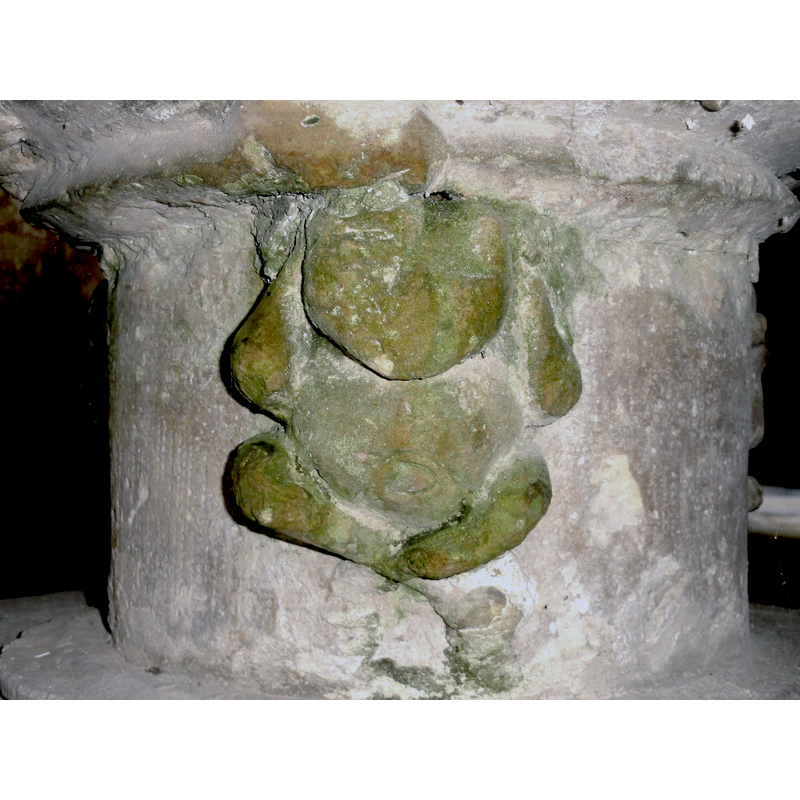 one of three; this one has the legs crossed and the arms to its ears (?)