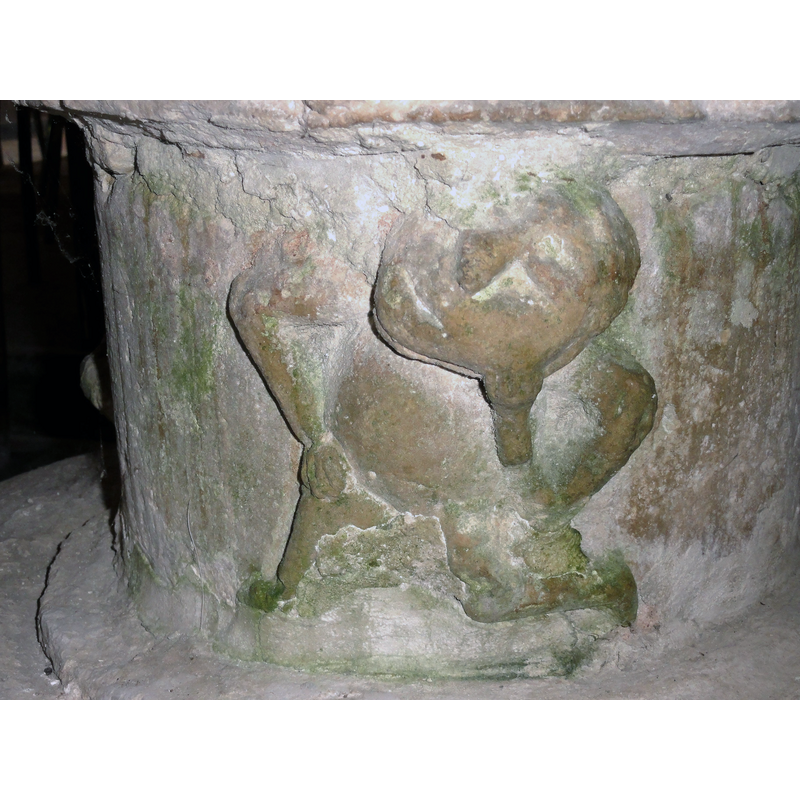 one of three; one arm akimbo, the other to its chin