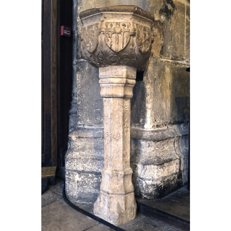 Source caption: "Église Saint-Merri (cuve baptismale aux armes de Louis XII et d'Anne de Bretagne) - Paris IV" [NB: it is not a font but a stoup, and the centre and right shields are charged with Instruments of the Passion; the left shield, much damaged, is supposed to have the arms of France and Britanny on it]