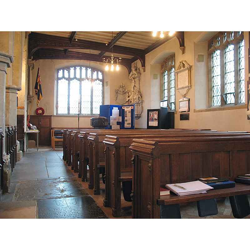 Source caption: "All Saints church, Sanderstead: north aisle. The north aisle of the church was added in the 19th century." -- the basin and cover of the modern font are visible at the far [west] end, behind the bank of benches, near the window