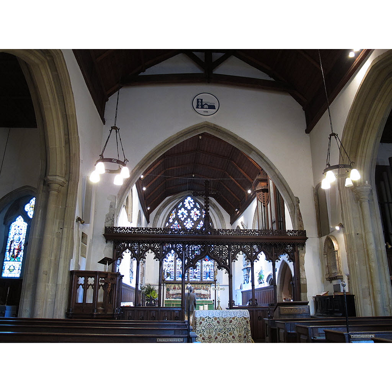 Source caption: "Interior of St Mary's church, Oxted. The church is grade 1 listed (list entry number 1189608). This view shows part of the nave, the ornate rood screen (19th century but in mediaeval style) and the chancel beyond."