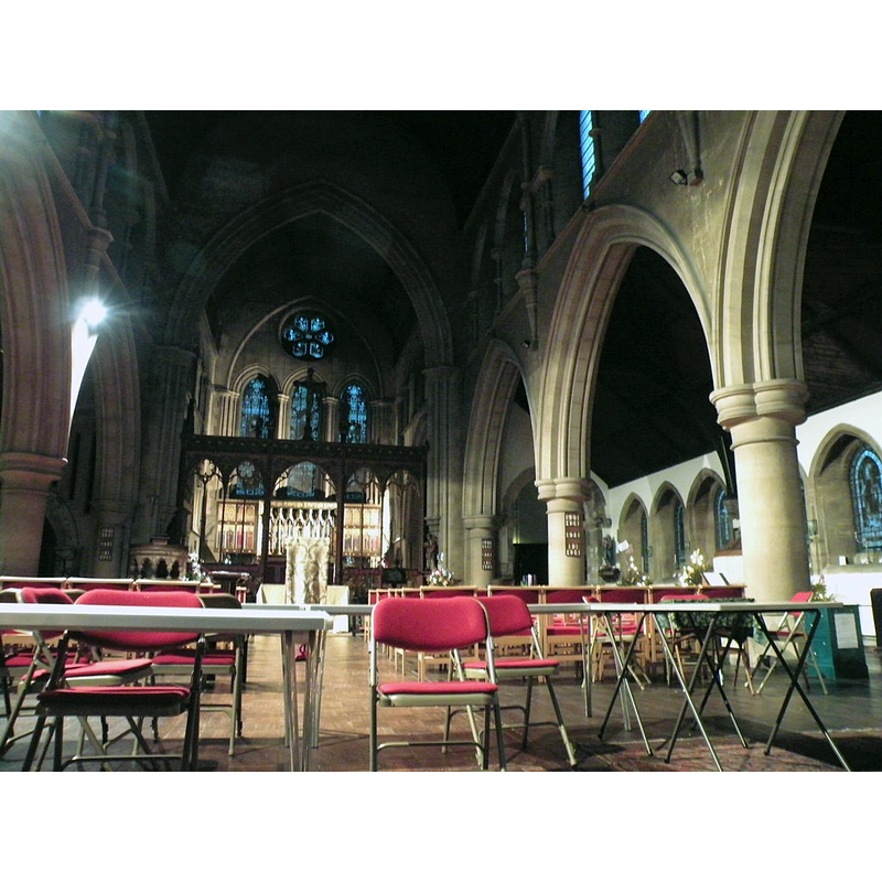 Source caption: "Interior of St Giles', Cambridge. The new church was completed in 1875 and, probably because of the constraints of the available site, is oriented closer to north-east than east. The rounded arch at the far end of the south aisle (partly concealed by a pillar) was preserved from an earlier church on the site."