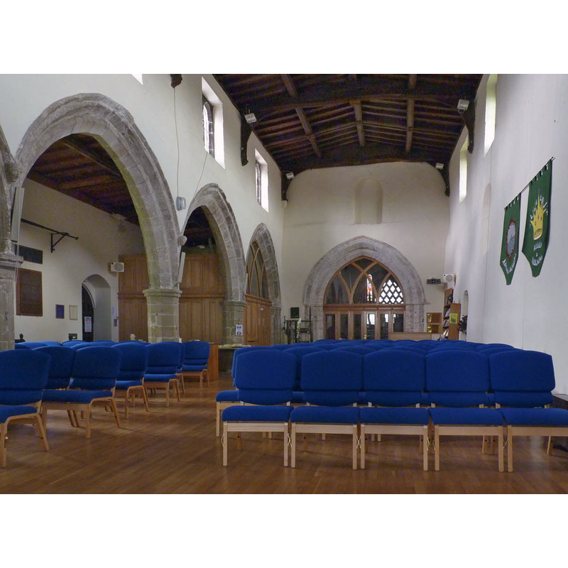 Source caption: "The nave, St Mary's, East Leake. The plain north wall is part of the original 12th century church. The arcade to the south aisle is 14th century with octagonal columns. Note the carved heads used as stops to the hood mould. Over the arch into the tower chamber is a blocked 12th century opening which probably gave access to a gallery in the nave. The floor and seating have been modernised in recent years, the latter replacing a number of early bench pews, some of which have been retained in the south aisle."