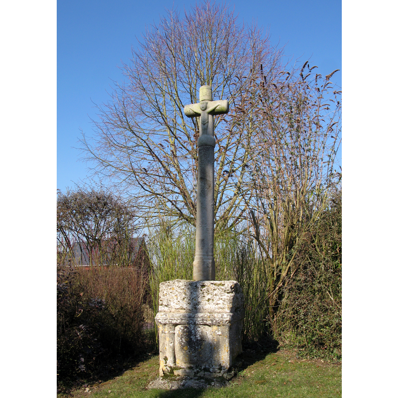 the calvary is located near the 'monument-aux-morts', not far from the churchyard
