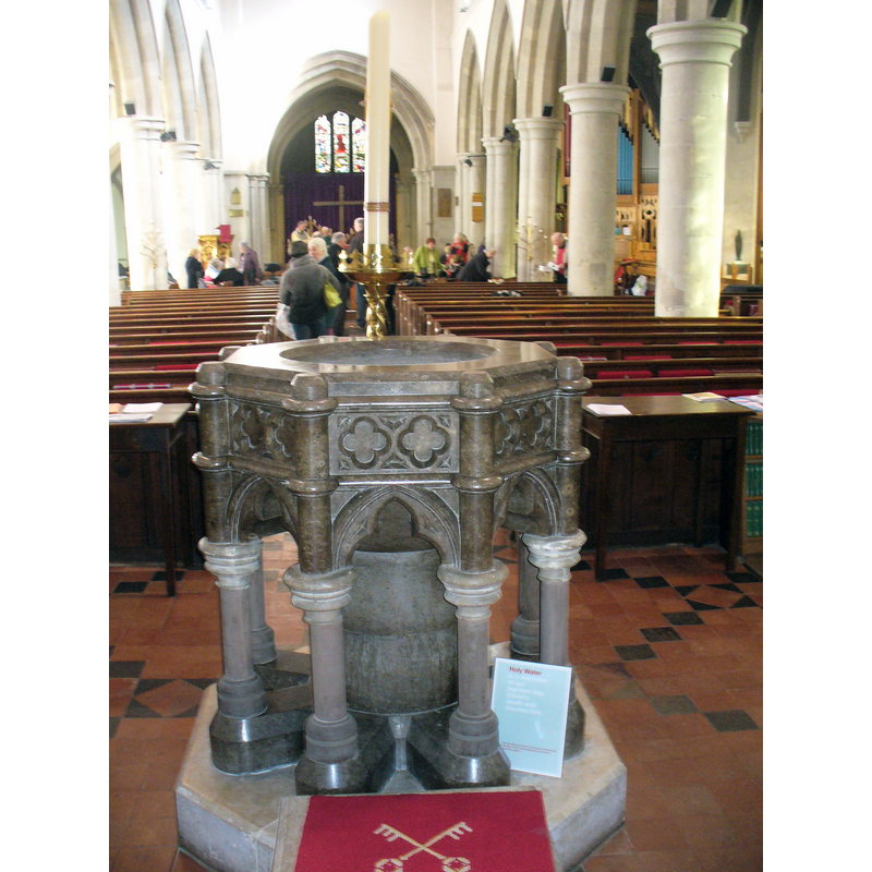 the modern font at the west end of the nave, looking east