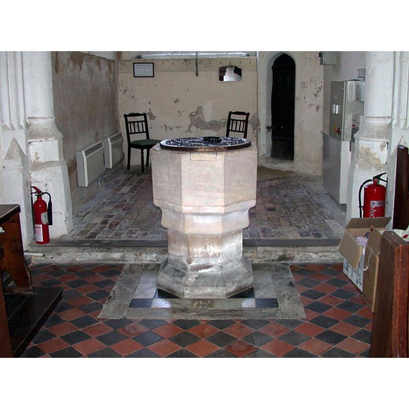 at the west end of the nave, just east of the tower arch