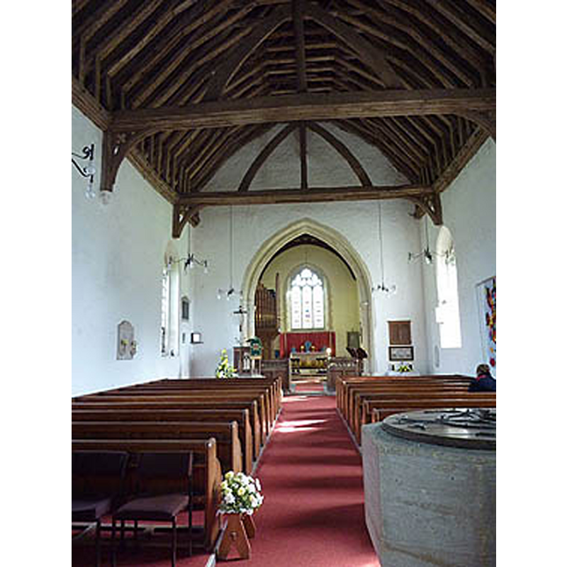 the basin of the re-cut font partially visible in the foregorund, south side of the nave