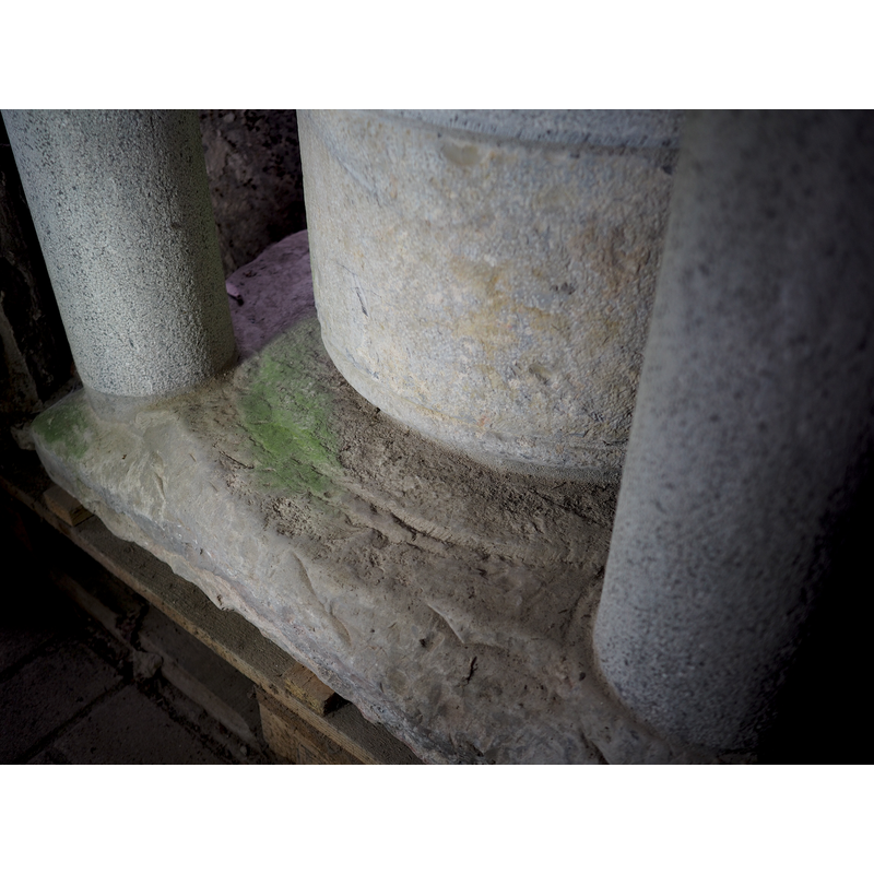 on the original lower base; very eroded, all detail gone now -- notice the modern replacement shafts