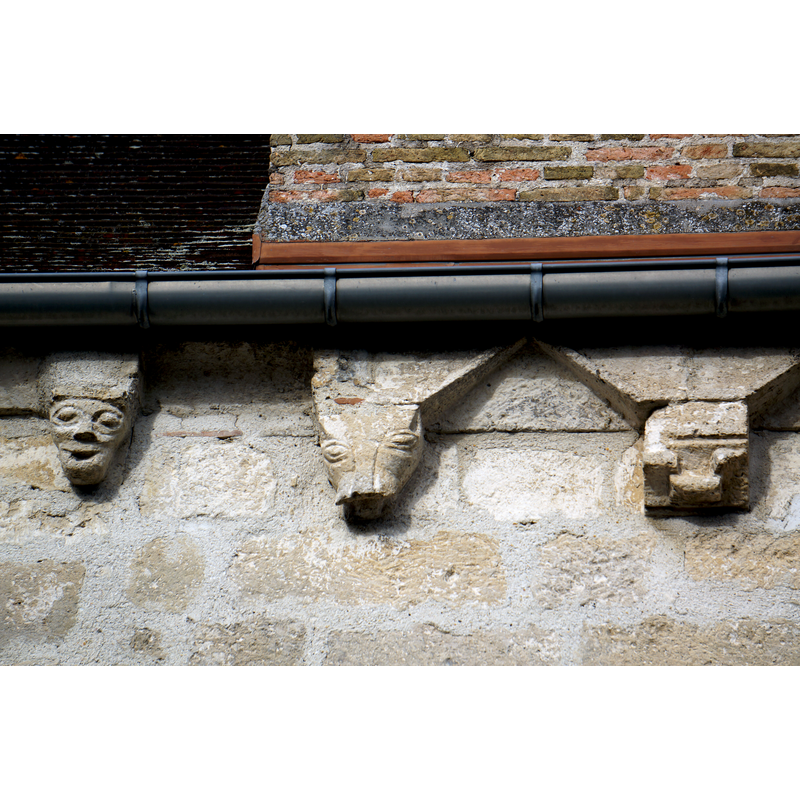 corbels on the courtyard side, just below the chimney
