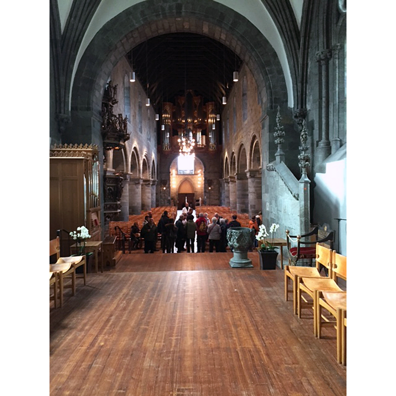 view west from the altar, across the chancel -with the font visible on the right, down all the way to the west entrance